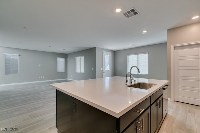 9239 Albus Hills Ave, Las Vegas, NV 89143 - kitchen with a sink, light wood finished floors, a kitchen island with sink, light countertops, and recessed lighting