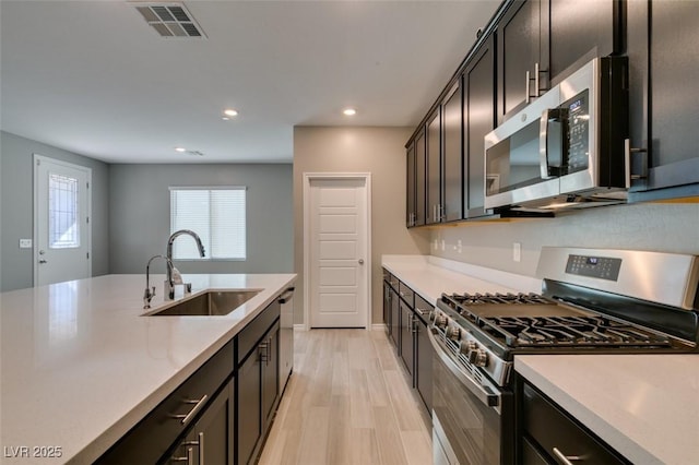 9239 Albus Hills Ave, Las Vegas, NV 89143 - kitchen with appliances with stainless steel finishes, a sink, light countertops, and recessed lighting