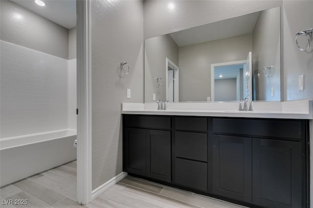 9239 Albus Hills Ave, Las Vegas, NV 89143 - bathroom featuring double vanity, wood tiled floors, and baseboards