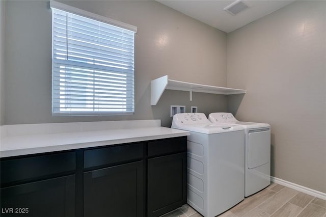 9239 Albus Hills Ave, Las Vegas, NV 89143 - laundry area with washer and dryer, cabinet space, baseboards, and wood finish floors