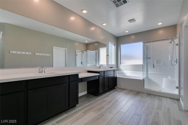 9239 Albus Hills Ave, Las Vegas, NV 89143 - full bath with a stall shower, a garden tub, two vanities, wood finished floors, and recessed lighting