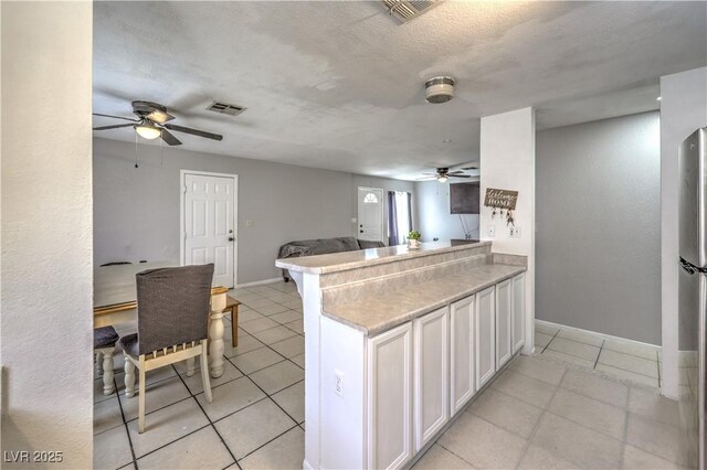 844 Balzar Ave, Las Vegas, NV 89106 - kitchen featuring a ceiling fan, light tile patterned floors, baseboards, open floor plan, and white cabinets