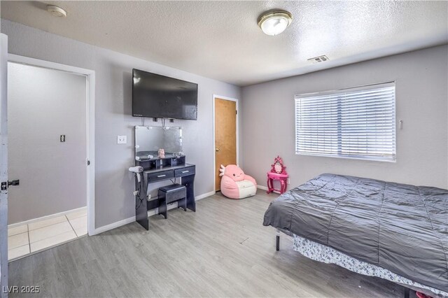 844 Balzar Ave, Las Vegas, NV 89106 - bedroom with wood finished floors, baseboards, and a textured ceiling