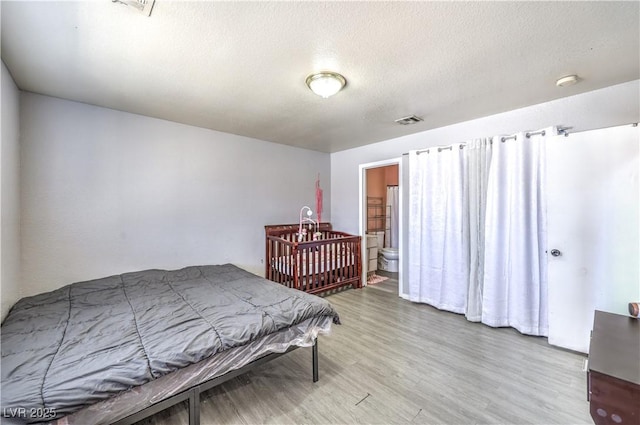 844 Balzar Ave, Las Vegas, NV 89106 - bedroom with wood finished floors and a textured ceiling