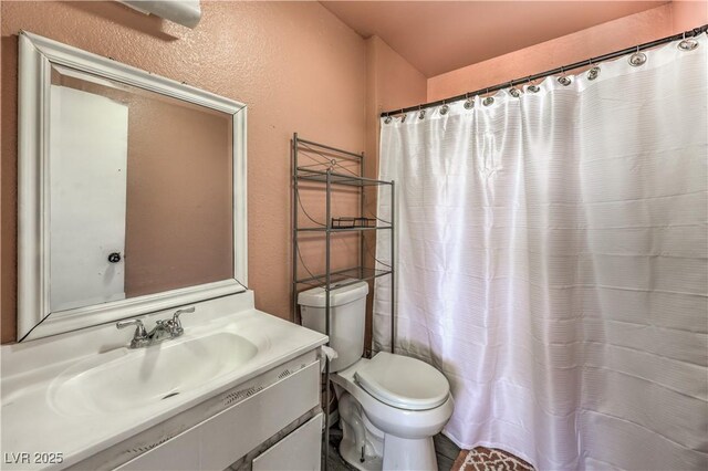 844 Balzar Ave, Las Vegas, NV 89106 - full bathroom with a textured wall, toilet, vanity, and a shower with shower curtain