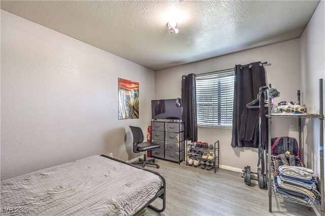 844 Balzar Ave, Las Vegas, NV 89106 - bedroom with baseboards, wood finished floors, and a textured ceiling