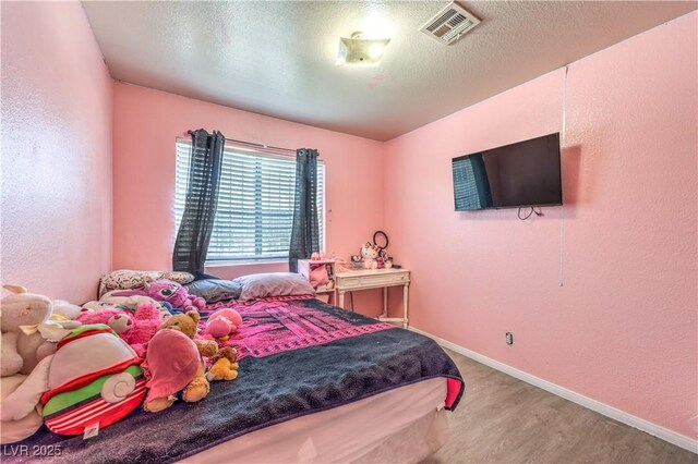 844 Balzar Ave, Las Vegas, NV 89106 - bedroom featuring wood finished floors, baseboards, a textured wall, and a textured ceiling