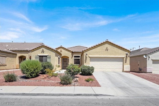 1212 E Rome Blvd, North Las Vegas, NV 89086 - mediterranean / spanish house with stucco siding, a garage, concrete driveway, and a tiled roof