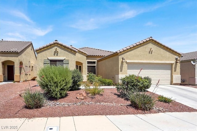 1212 E Rome Blvd, North Las Vegas, NV 89086 - mediterranean / spanish-style house featuring a garage, stucco siding, concrete driveway, and a tiled roof