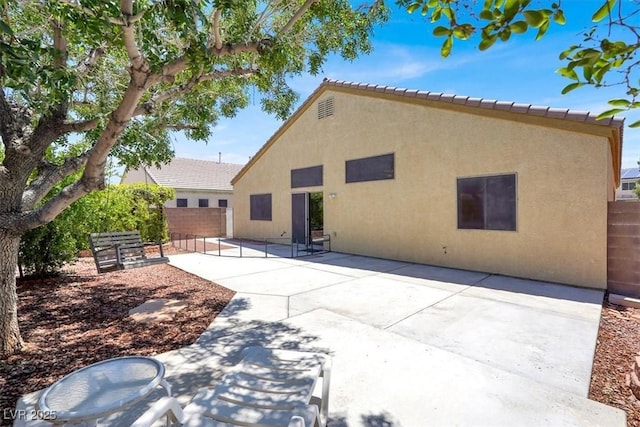 1212 E Rome Blvd, North Las Vegas, NV 89086 - back of property with a patio, stucco siding, and a tile roof