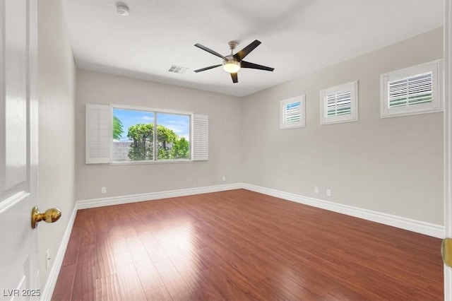 1212 E Rome Blvd, North Las Vegas, NV 89086 - spare room with dark wood-style floors, a ceiling fan, baseboards, and a smoke detector