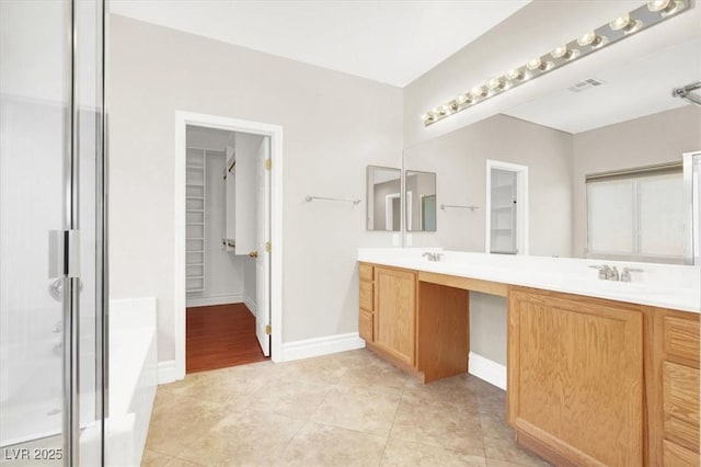 1212 E Rome Blvd, North Las Vegas, NV 89086 - full bathroom with double vanity, a shower stall, a spacious closet, and a garden tub