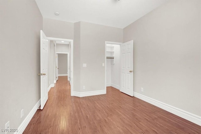 1212 E Rome Blvd, North Las Vegas, NV 89086 - unfurnished bedroom featuring wood finished floors, baseboards, and a closet