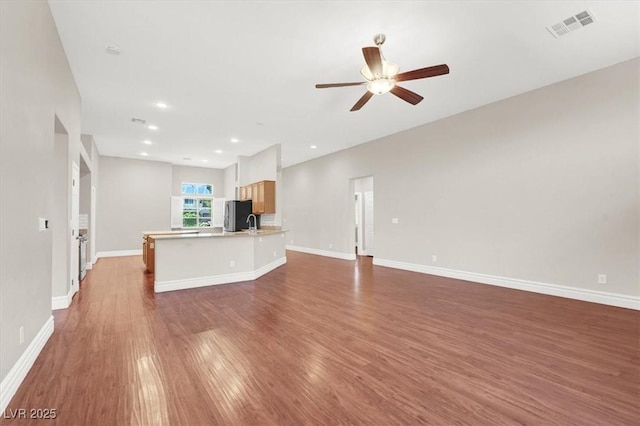 1212 E Rome Blvd, North Las Vegas, NV 89086 - unfurnished living room featuring ceiling fan, wood finished floors, baseboards, and recessed lighting