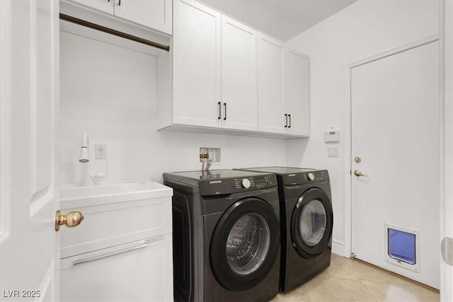1212 E Rome Blvd, North Las Vegas, NV 89086 - washroom featuring separate washer and dryer, cabinet space, and light tile patterned floors