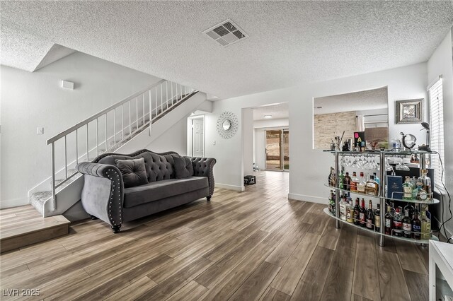 2507 Albemarle Way, Henderson, NV 89014 - living area featuring stairs, wood finished floors, a textured ceiling, and baseboards