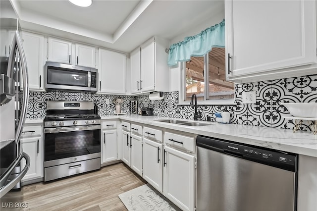2507 Albemarle Way, Henderson, NV 89014 - kitchen featuring stainless steel appliances, a sink, white cabinets, and light wood-style flooring