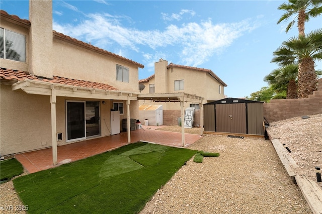 2507 Albemarle Way, Henderson, NV 89014 - back of property featuring a patio area, a fenced backyard, stucco siding, a tiled roof, and a pergola