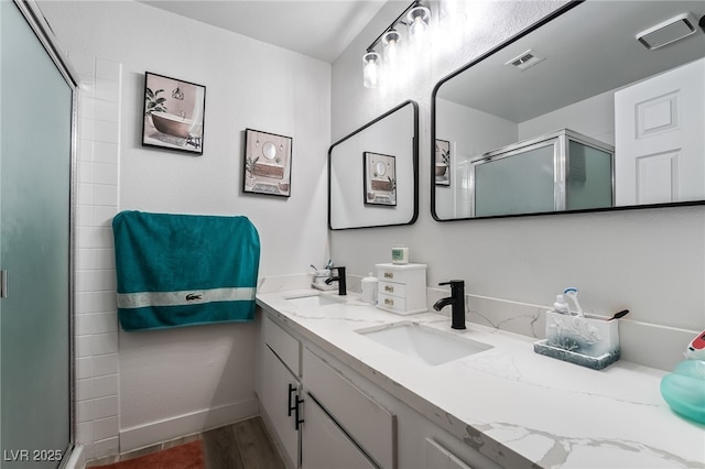 2507 Albemarle Way, Henderson, NV 89014 - bathroom featuring a stall shower, wood finished floors, double vanity, and baseboards
