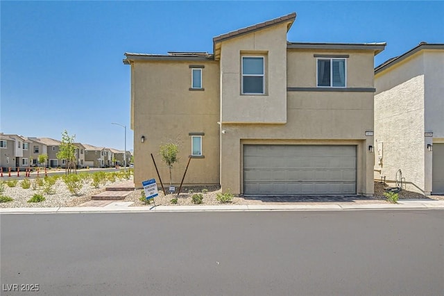 6835 Orange Horizon St, North Las Vegas, NV 89086 - townhome / multi-family property featuring an attached garage, stucco siding, and a residential view