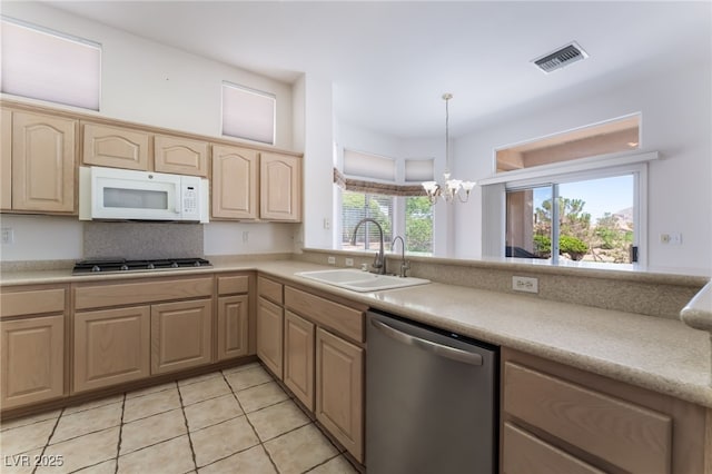 9812 Folsom Dr, Las Vegas, NV 89134 - kitchen featuring dishwasher, white microwave, a sink, gas stovetop, and light brown cabinets
