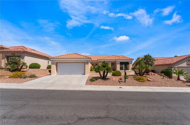 9812 Folsom Dr, Las Vegas, NV 89134 - mediterranean / spanish-style home with stucco siding, an attached garage, concrete driveway, and a tiled roof