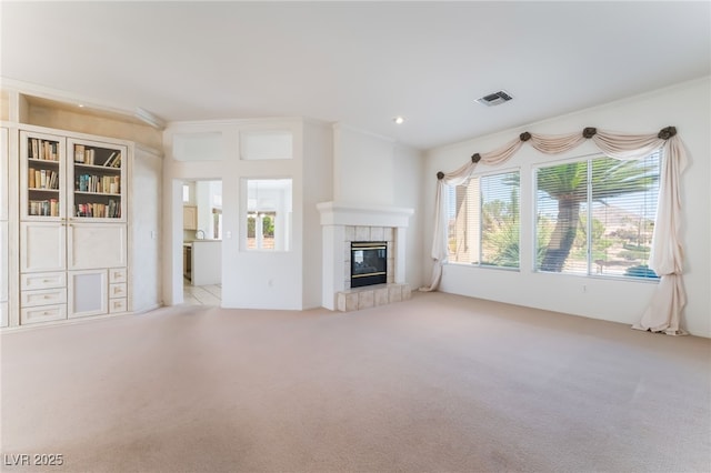 9812 Folsom Dr, Las Vegas, NV 89134 - unfurnished living room with carpet flooring, a tiled fireplace, and crown molding