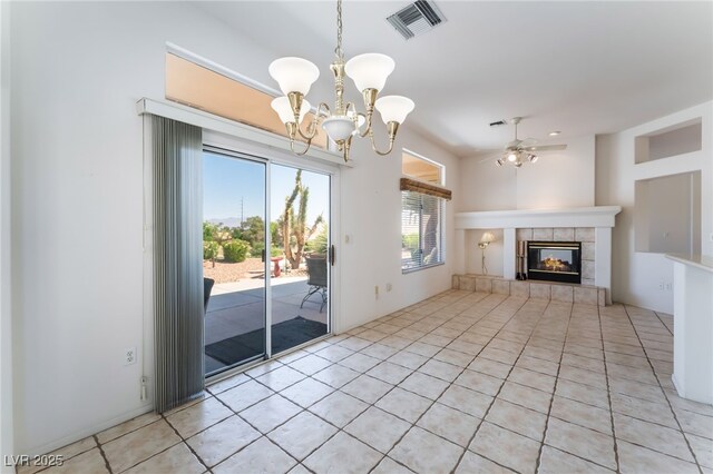 9812 Folsom Dr, Las Vegas, NV 89134 - unfurnished living room featuring a ceiling fan, a chandelier, a fireplace, and light tile patterned flooring