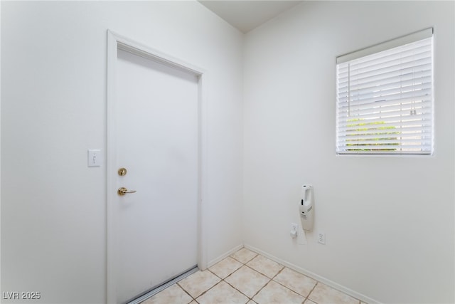 9812 Folsom Dr, Las Vegas, NV 89134 - laundry room with light tile patterned floors and baseboards