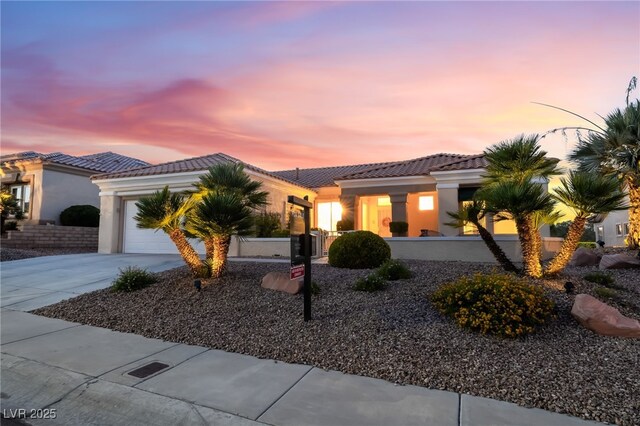 9812 Folsom Dr, Las Vegas, NV 89134 - view of front facade with a tiled roof, stucco siding, an attached garage, and concrete driveway