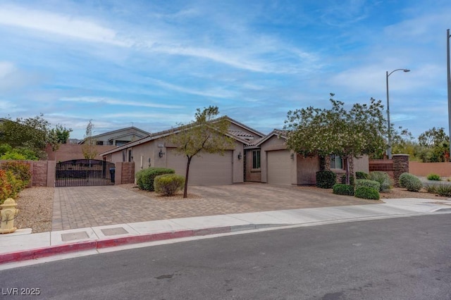 6985 Hopi Summit Ct, Las Vegas, NV 89149 - view of front of property featuring a gate, an attached garage, decorative driveway, and stucco siding