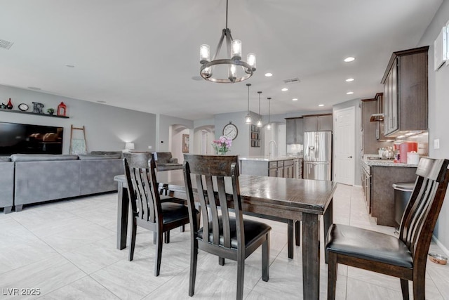 6985 Hopi Summit Ct, Las Vegas, NV 89149 - dining room with arched walkways, a chandelier, and recessed lighting