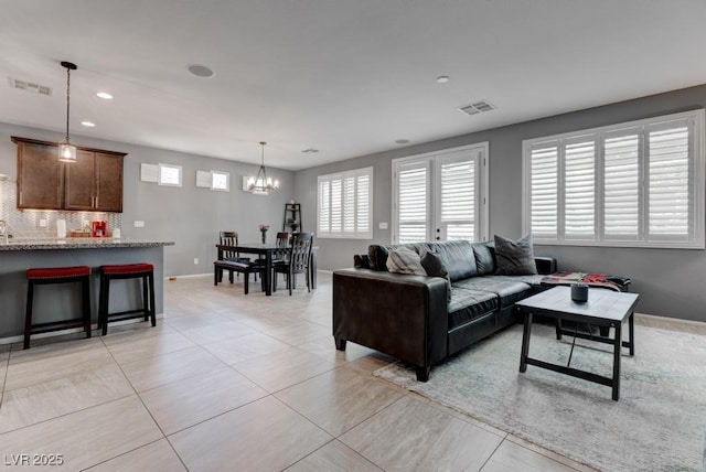 6985 Hopi Summit Ct, Las Vegas, NV 89149 - living area featuring a chandelier, light tile patterned floors, baseboards, and recessed lighting