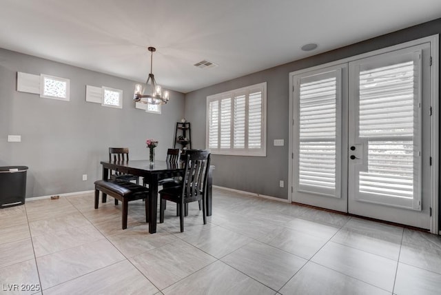 6985 Hopi Summit Ct, Las Vegas, NV 89149 - dining space featuring a chandelier, baseboards, french doors, and light tile patterned floors