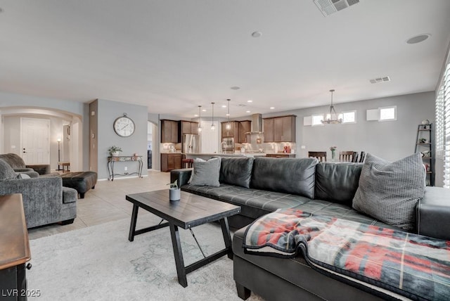 6985 Hopi Summit Ct, Las Vegas, NV 89149 - living area featuring a chandelier, arched walkways, and light tile patterned floors