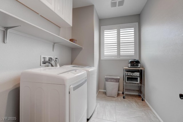 6985 Hopi Summit Ct, Las Vegas, NV 89149 - laundry room featuring separate washer and dryer, cabinet space, and baseboards