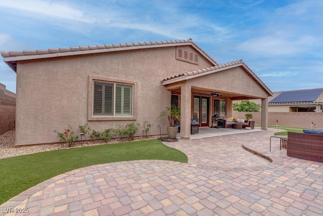 6985 Hopi Summit Ct, Las Vegas, NV 89149 - back of property featuring an outdoor living space, a patio, a ceiling fan, and stucco siding