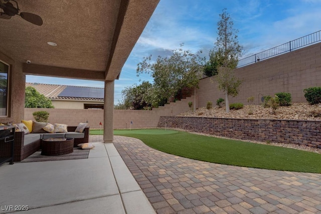 6985 Hopi Summit Ct, Las Vegas, NV 89149 - fenced backyard with a patio area, a putting area, and an outdoor hangout area