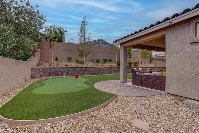 6985 Hopi Summit Ct, Las Vegas, NV 89149 - fenced backyard featuring an area to practice putting and a patio area