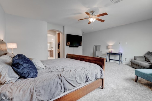 6985 Hopi Summit Ct, Las Vegas, NV 89149 - bedroom with arched walkways, carpet floors, a ceiling fan, and connected bathroom