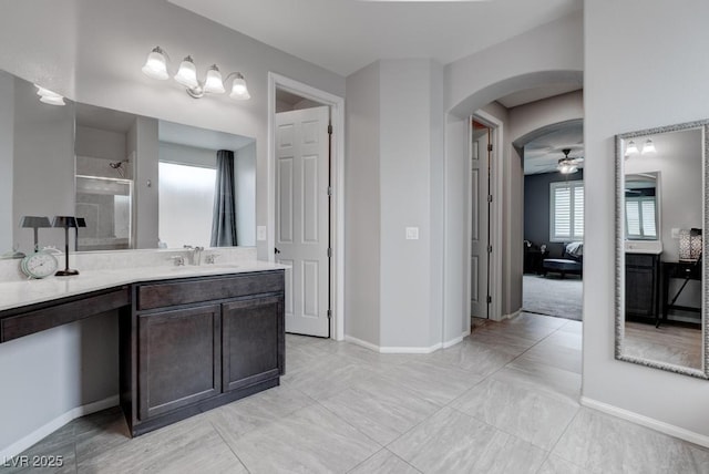 6985 Hopi Summit Ct, Las Vegas, NV 89149 - bathroom with a walk in shower, baseboards, a ceiling fan, and vanity