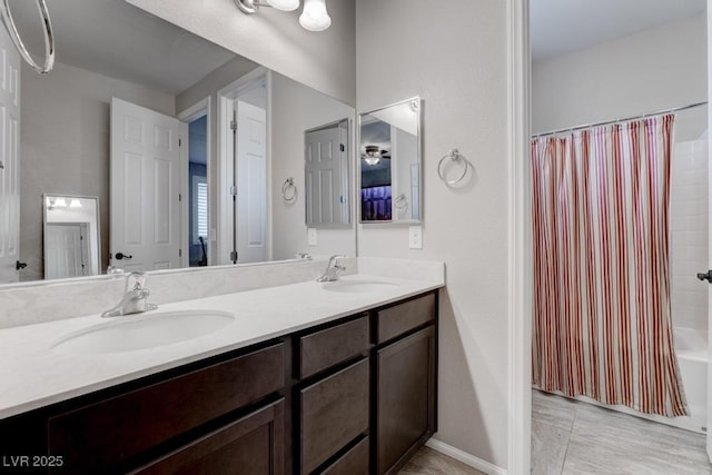 6985 Hopi Summit Ct, Las Vegas, NV 89149 - bathroom with double vanity, shower / bath combo with shower curtain, and baseboards