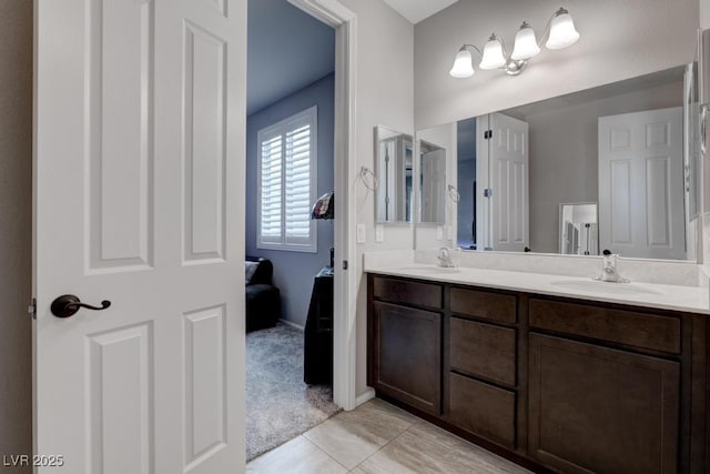 6985 Hopi Summit Ct, Las Vegas, NV 89149 - full bathroom featuring double vanity, ensuite bath, baseboards, and tile patterned floors