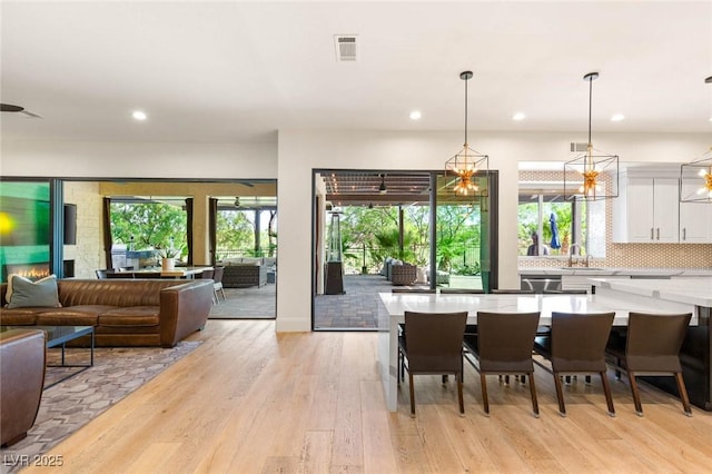10301 Orkiney Dr, Las Vegas, NV 89144 - dining room featuring recessed lighting, healthy amount of natural light, and light wood finished floors