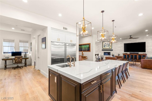 10301 Orkiney Dr, Las Vegas, NV 89144 - kitchen with a sink, built in refrigerator, a ceiling fan, light wood finished floors, and recessed lighting