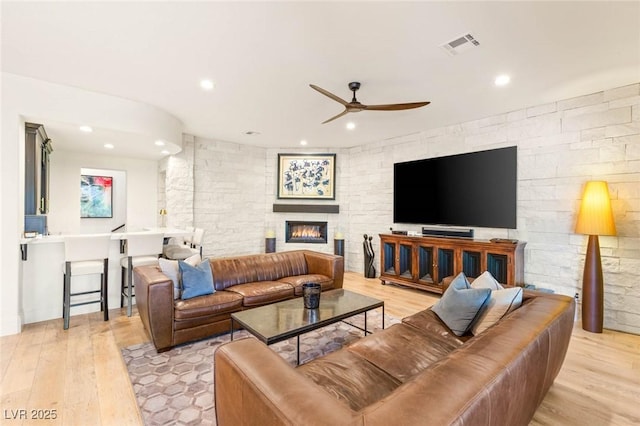 10301 Orkiney Dr, Las Vegas, NV 89144 - living room with ceiling fan, light wood-style flooring, recessed lighting, and a large fireplace