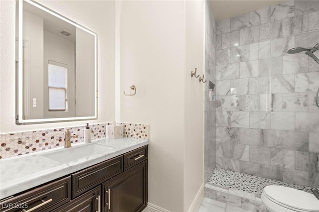 10301 Orkiney Dr, Las Vegas, NV 89144 - bathroom with a walk in shower, toilet, vanity, baseboards, and tasteful backsplash