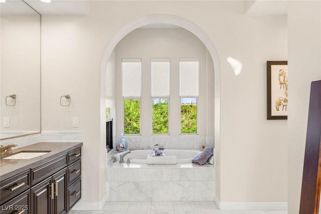 10301 Orkiney Dr, Las Vegas, NV 89144 - full bathroom featuring vanity, a garden tub, and marble look tile flooring
