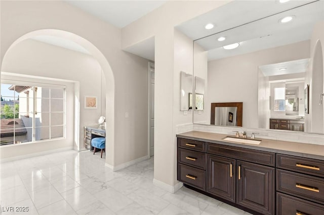 10301 Orkiney Dr, Las Vegas, NV 89144 - bathroom featuring baseboards, marble look tile flooring, vanity, and recessed lighting