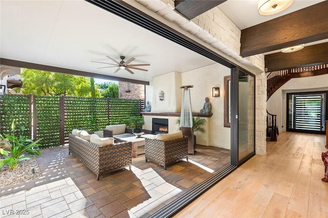 10301 Orkiney Dr, Las Vegas, NV 89144 - view of patio with a ceiling fan and an outdoor living space with a fireplace